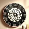 Artistic Design & Craftsmanship Kolam-Inspired Mandala Pattern: The heart of this clock features a sacred geometric floral motif, symbolizing balance, unity, and positive energy. Luxury Black & White Contrast: The bold jet-black resin base paired with shimmering white mandala details creates a striking, high-end look. Crystal Studded Roman Numerals: Each numeral is designed with embedded shimmering stones, offering sparkle and a regal touch. Intricate Resin Detailing: Hand-poured resin with precision artistry ensures a smooth glossy finish that enhances the luxurious aesthetic. Kolam Mandala Resin Clock